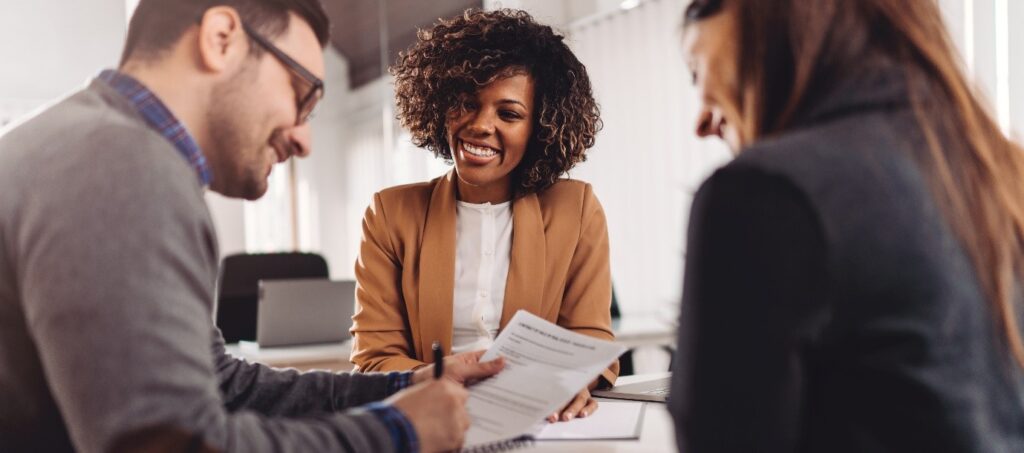 Three people discussing a contract