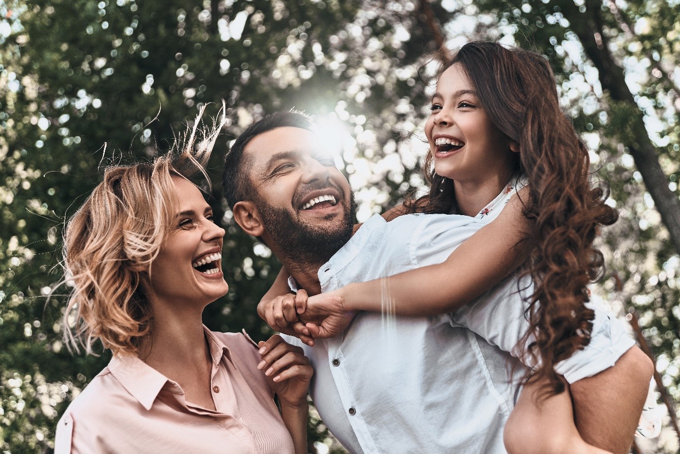 Mother, father and daughter all smiling